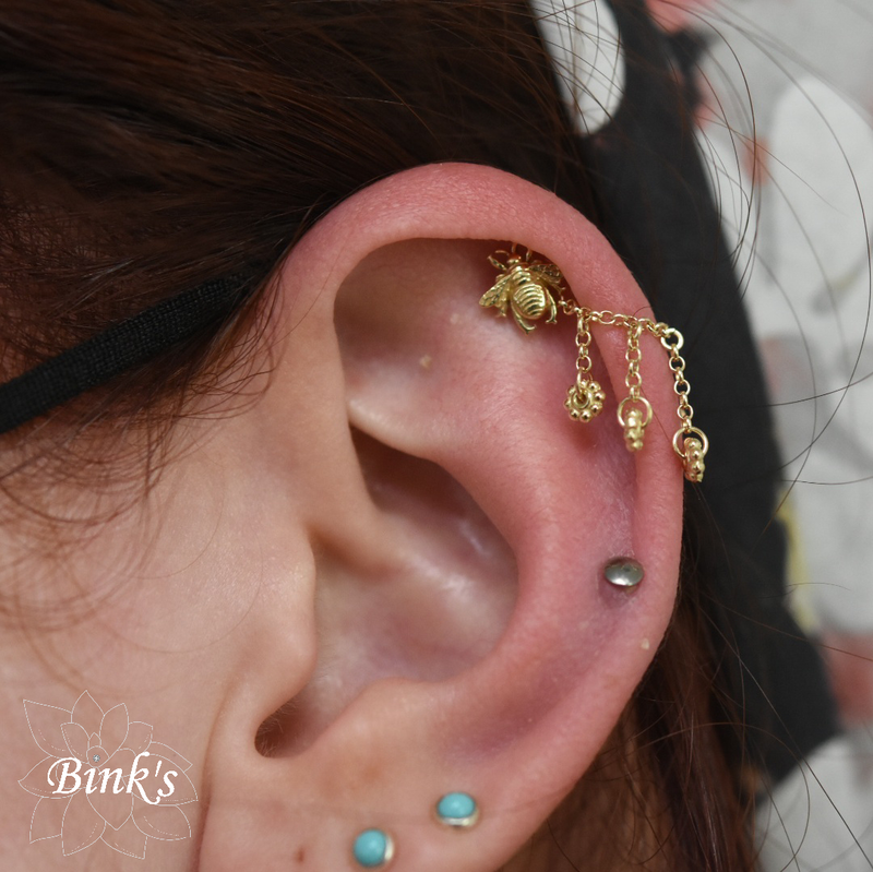 BVLA bumblebee in yellow gold healed cartilage piercing with Flower Child cable chain and dangles from Hialeah Fine Jewelry